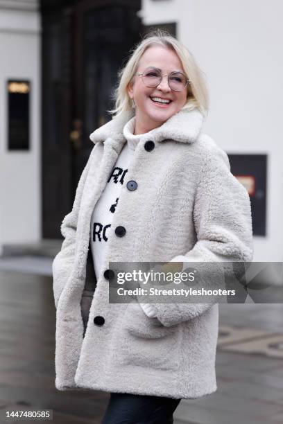 German TV presenter Ulla Kock am Brink wearing a short beige teddy coat by Zadig & Voltaire, a beige knitted turtleneck pullover by Zadig & Voltaire...