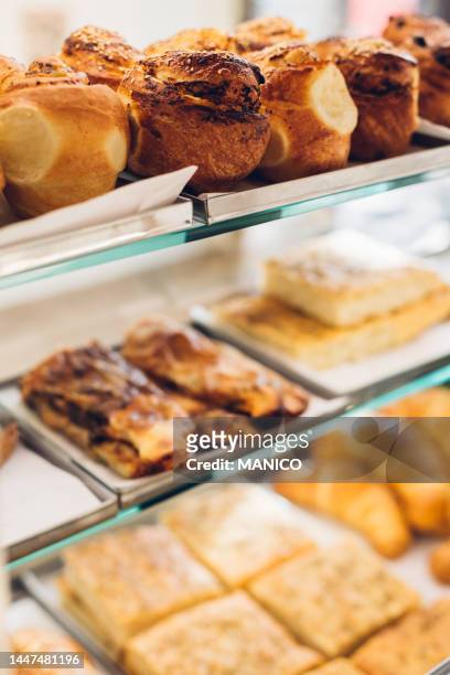 pasties on a display case at the bakery - boulangerie vitrine stock pictures, royalty-free photos & images