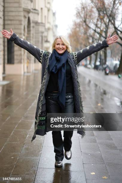 German TV presenter Ulla Kock am Brink wearing a long multicolored coat with fringe detail by Zadig & Voltaire, a dark blue scarf by Zadig &...