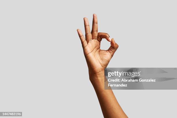 background of an african hand gesturing to be okay - daumen stock-fotos und bilder