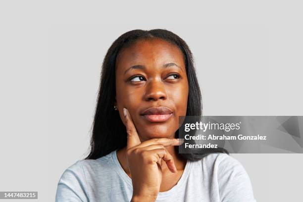 close up photo of an african woman expressing doubt - suspicious activity stock pictures, royalty-free photos & images