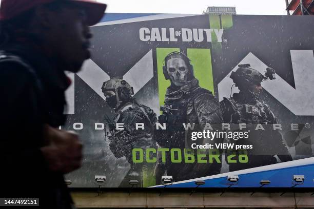 Man walks near Call of Duty game publicity on December 7, 2022 in New York City. Microsoft has entered into a commitment to bring the gaming Call of...