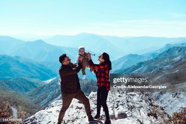 family with small baby relaxing during mountain travels - small man and tall woman stock pictures, royalty-free photos & images