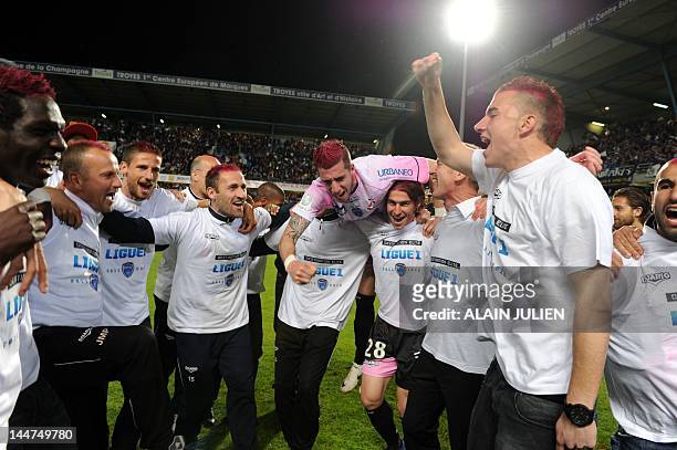 Troyes' football club players celebrate at the end of the French L2 football match Troyes vs Amiens on May 18 the Aube Stadium in Troyes. Troyes won...