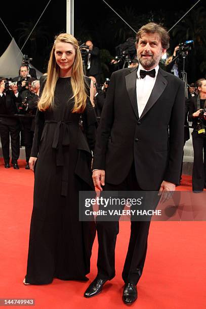 President of the 65th Cannes Film Festival jury Nanni Moretti and Chiara Palmieri arrive for the screening of "Reality" presented in competition at...