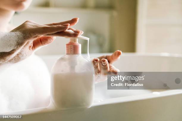 dispenser with white liquid soap or shower gel, for intimate hygiene. moisturizing, cleansing - bathroom routine stock pictures, royalty-free photos & images