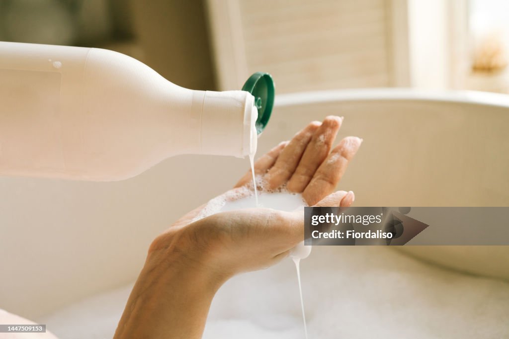Dispenser with white liquid soap or shower gel, for intimate hygiene.