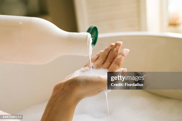 dispenser with white liquid soap or shower gel, for intimate hygiene. - woman shampoo stock pictures, royalty-free photos & images