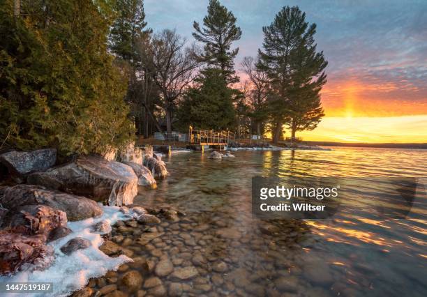 cut river dam icy sunset - michigan winter bildbanksfoton och bilder