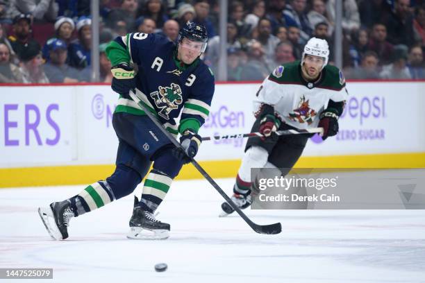 Miller of the Vancouver Canucks waits for a pass as Nick Schmaltz of the Arizona Coyotes defends during the third period of their NHL game at Rogers...