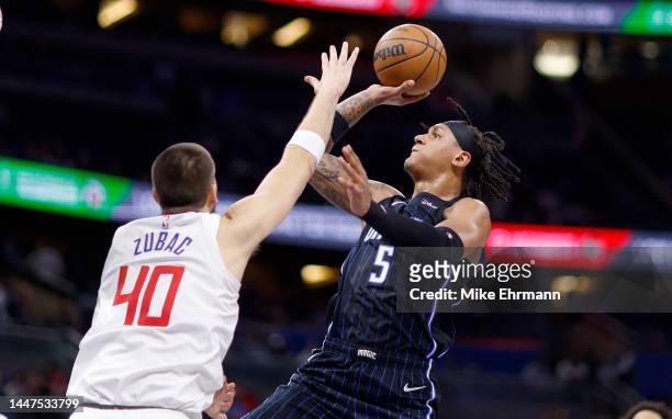 Paolo Banchero of the Orlando Magic drives on Ivica Zubac of the LA Clippers during a game at Amway Center on December 07, 2022 in Orlando, Florida....