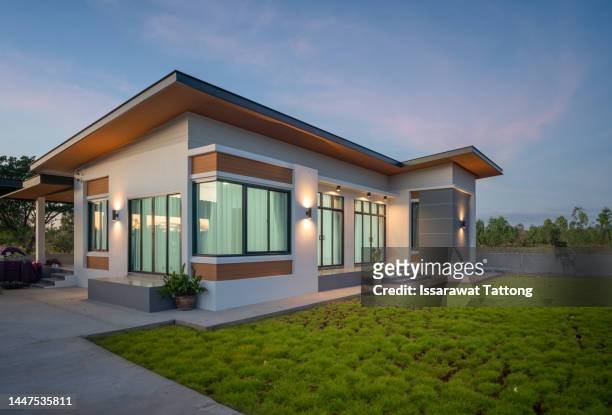 beautiful modern style luxury home at sunset, elegant design - large grass area stock pictures, royalty-free photos & images