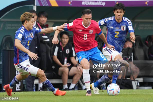 Bryan Oviedo of Costa Rica in action under pressure from Ritsu Doan and Miki Yamane of Japan during the FIFA World Cup Qatar 2022 Group E match...