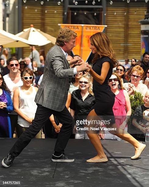 Nigel Lythgoe dances with Maria Menounos at "Extra" at The Grove on May 18, 2012 in Los Angeles, California.