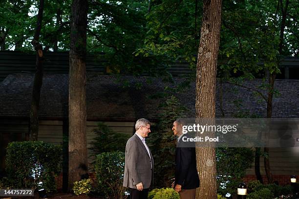 President Barack Obama greets Canadian Prime Minister Stephen Harper in front of Laurel Lodge at Camp David during the 2012 G8 Summit on Friday, May...