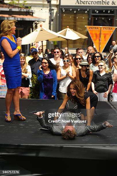 Mary Murphy watches Nigel Lythgoe dance with Maria Menounos at "Extra" at The Grove on May 18, 2012 in Los Angeles, California.