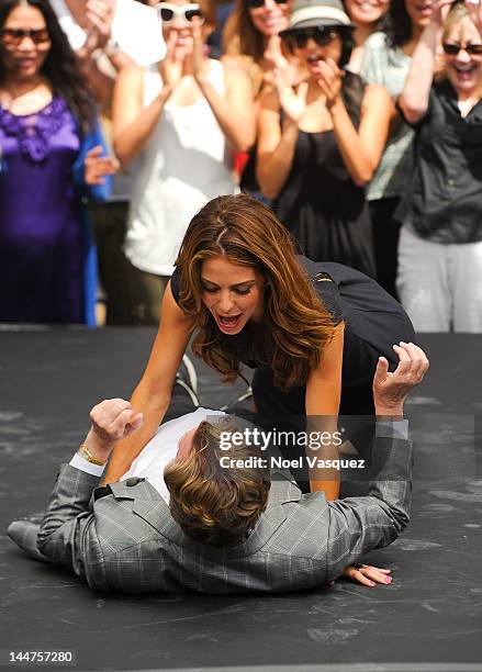 Nigel Lythgoe dances with Maria Menounos at "Extra" at The Grove on May 18, 2012 in Los Angeles, California.