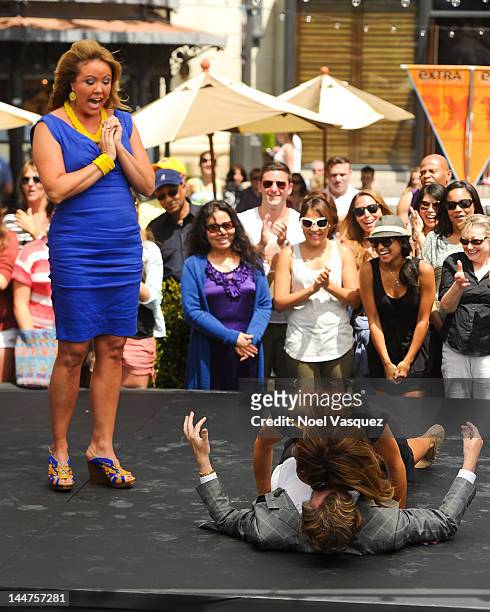 Mary Murphy watches Nigel Lythgoe dance with Maria Menounos at "Extra" at The Grove on May 18, 2012 in Los Angeles, California.