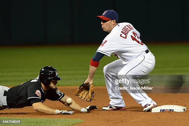 Shortstop Asdrubal Cabrera of the Cleveland Indians can't make the catch as Bryan Petersen of the Miami Marlins dives back to second during the...