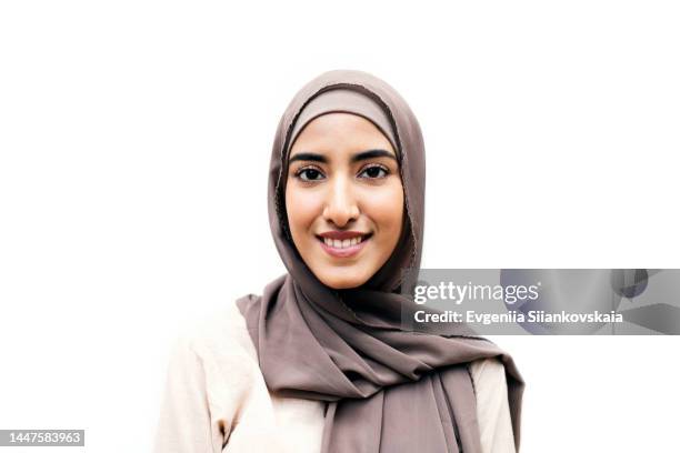 portrait of cheerful muslim woman outdoors against white background. - woman hijab stock-fotos und bilder