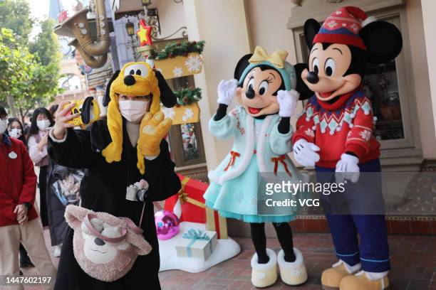 Tourist takes a selfie with Disney characters in the Shanghai Disneyland on December 8, 2022 in Shanghai, China. Shanghai Disneyland reopened on...