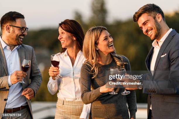 happy business couples enjoying in wine and talk on a terrace. - na werktijd stockfoto's en -beelden