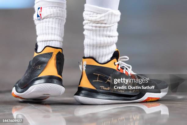 View of the sneakers of Kyrie Irving of the Brooklyn Nets with logos covered in tape during the fourth quarter of the game against the Charlotte...