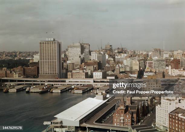 View from Sydney Harbour Bridge of the Circular Quay wharves and Overseas Passenger Terminal overlooked by the recently completed AMP Building office...