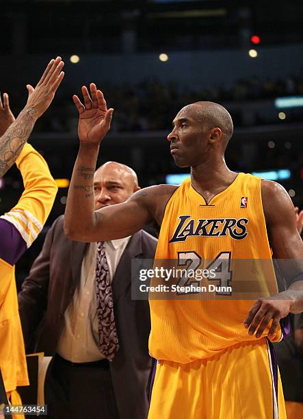 Kobe Bryant of the Los Angeles Lakers high fives with teammates after the game against the Oklahoma City Thunder in Game Three of the Western...