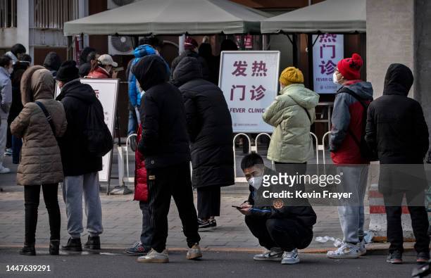 People line up at the fever clinic of a hospital on December 7, 2022 in Beijing, China. As part of a 10 point directive, Chinas government announced...