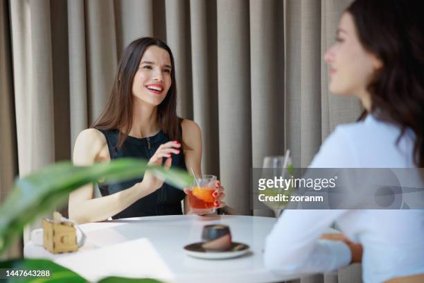 beautiful woman having cocktail in business investment meeting with her partner - bar drink establishment stock pictures, royalty-free photos & images