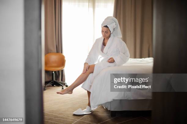 this already feels great on my skin - bathrobe stock pictures, royalty-free photos & images