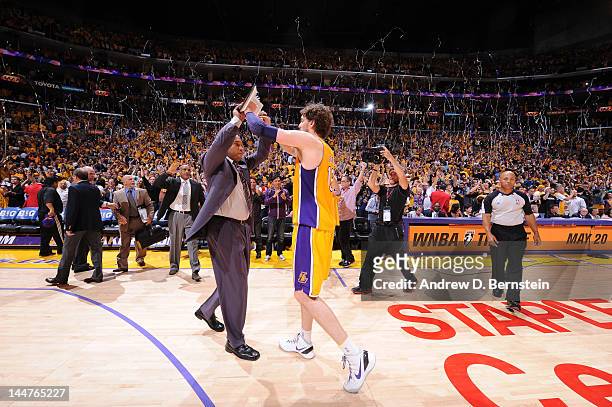 Assistant Coach Darvin Ham of the Los Angeles Lakers slaps hands with Pau Gasol following their team's victory over the Oklahoma City Thunder in Game...