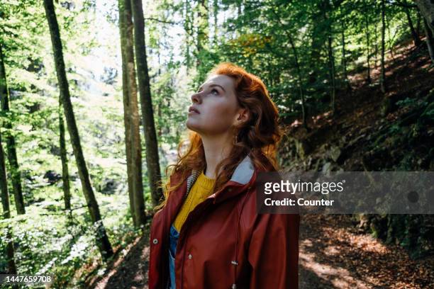 woman with red hair in forest looking up - forest bathing stock pictures, royalty-free photos & images