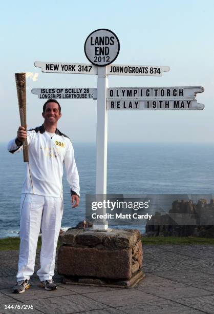 Olympic gold medal sailor and the first London 2012 torchbearer, Ben Ainslee, poses for a photograph beside the Lands End sign on May 19, 2012 in...