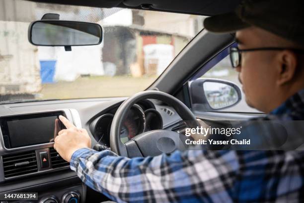 man putting direction of they work in gps of car - auto accessories stock pictures, royalty-free photos & images