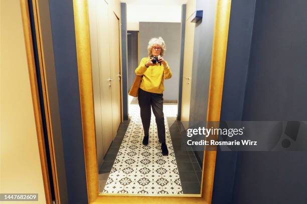 senior woman taking shot against mirror - mirror selfie stock pictures, royalty-free photos & images