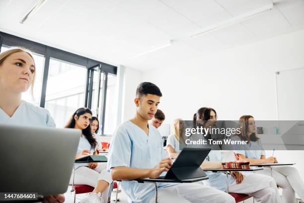 student dentists typing on laptops during lecture - medical student stock pictures, royalty-free photos & images