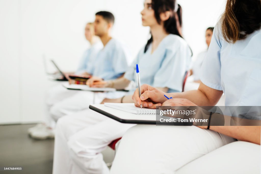 Student Dentists Taking Notes During Lecture