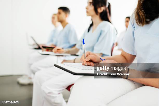 student dentists taking notes during lecture - long term care stock pictures, royalty-free photos & images