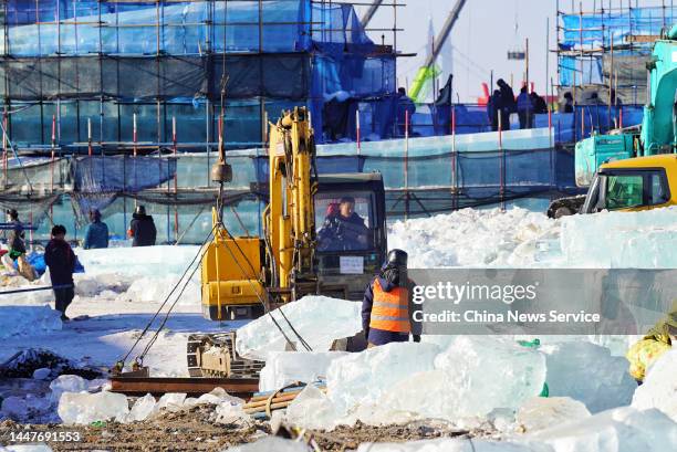 Workers build ice sculptures at the construction site of the 24th Harbin Ice and Snow World on December 8, 2022 in Harbin, Heilongjiang Province of...