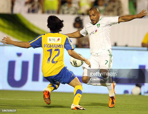 Al-Ahli player Victor Simoes de Oliveira of Brasil fights for the ball with Al-Nasr player Khaled Ahmed al-Ghamdi during the Saudi King Cup of...