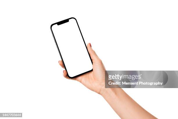 hand holding modern mobile phone iphone mockup with white screen on white background - menselijke hand stockfoto's en -beelden