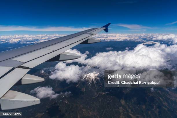 journey transport airplane window view himalayan mountain. travel concepts. - mountain peak logo stock pictures, royalty-free photos & images