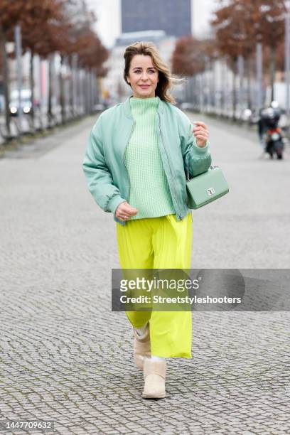 German TV presenter Bettina Cramer wearing a mint green knitted pullover by Selected femme, a mint green bomber jacket by JJXX, a lime green long...