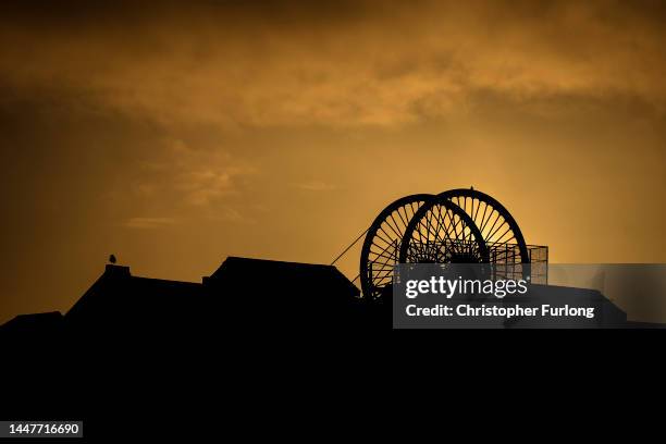 The sun sets behind the winding wheel of Haig Colliery Mining Museum adjacent to the West Cumbria Mining offices who have been given approval to once...