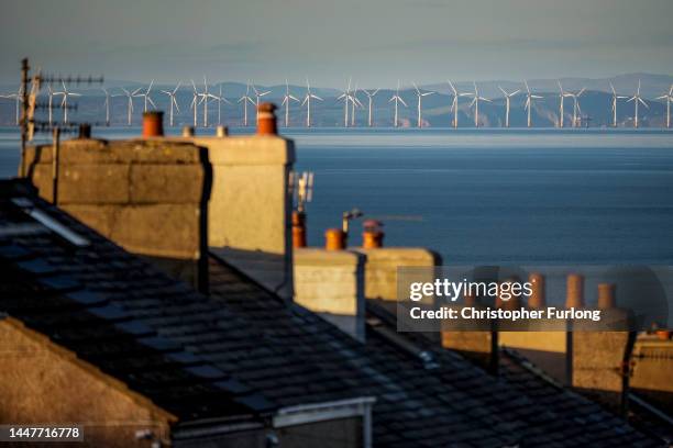 The Robin Rigg wind farm in the Solway Firth is seen over homes in Whitehaven where West Cumbria Mining have been given approval to once again...