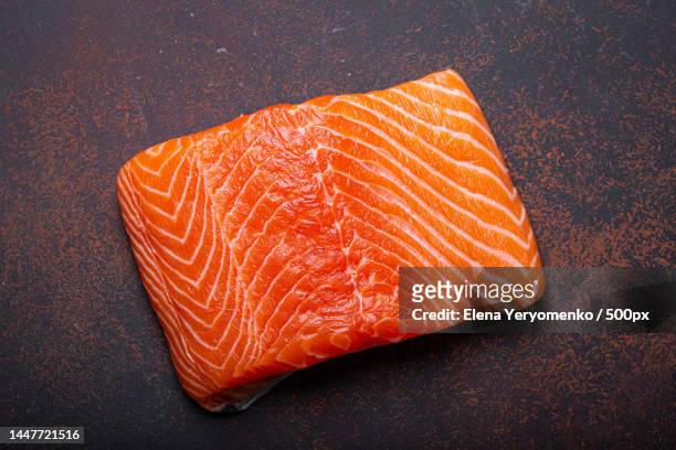 piece of fresh norwegian raw salmon fillet on dark brown rustic - rustic salmon fillets stock pictures, royalty-free photos & images
