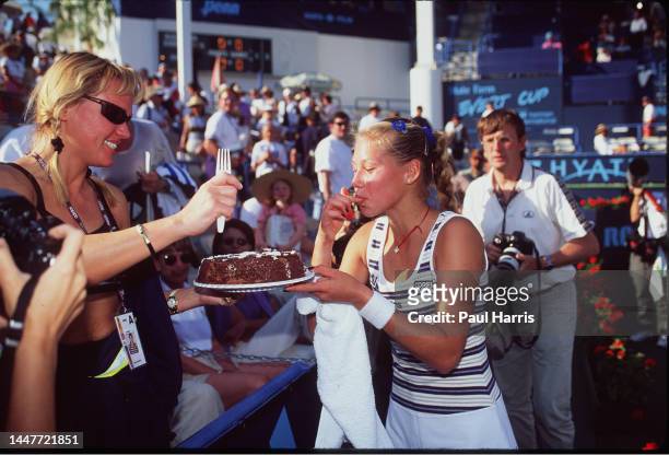 Teenage tennis star Anna Kournikova givers her mother Alla a birthday cake at the State Farm/Evert Cup Tournament March 8 1998 at the Grand Champions...