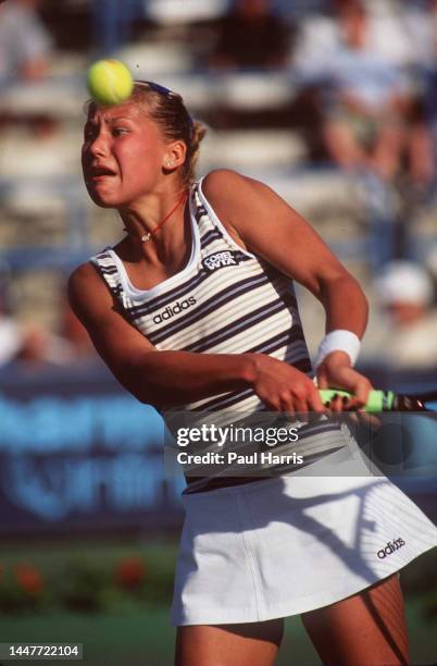 Teenage tennis star Anna Kournikova hits a backhand at the State Farm/Evert Cup Tournament March 8 1998 at the Grand Champions Resort in Indian...